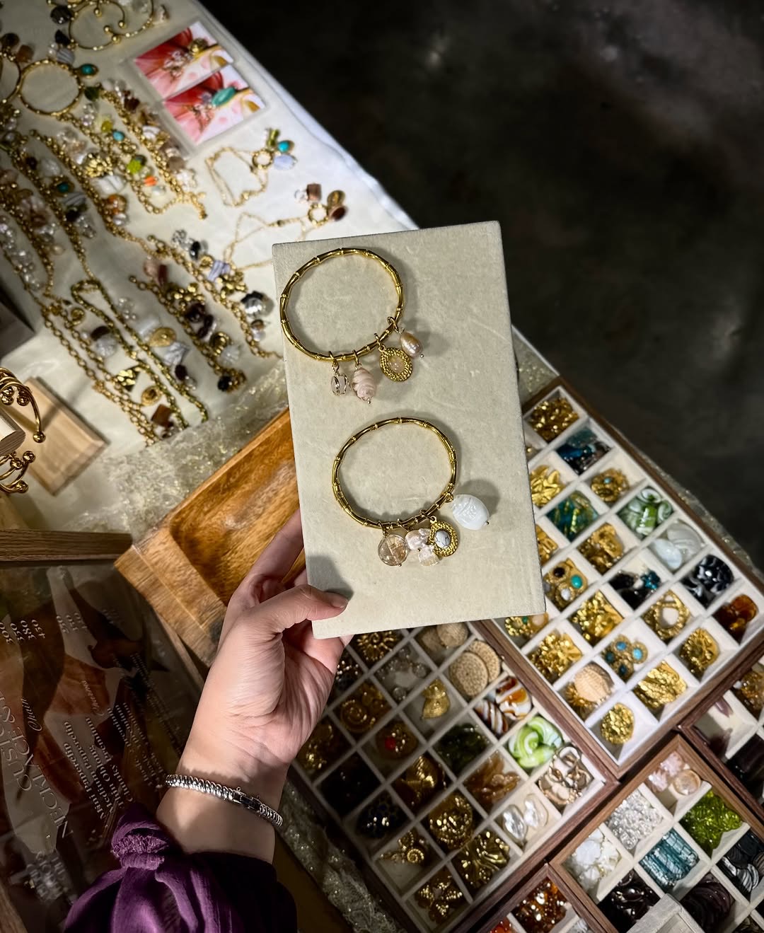 Curated charm bracelet selection at booth display